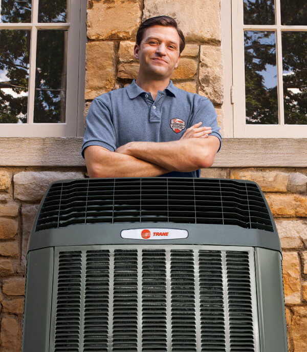 Trane Tech Standing Behind Air Conditioner